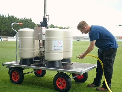 Setting up a portable irrigation system on a sports pitch
