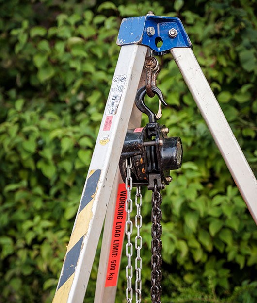 A frame and winch system used to lower in a pump