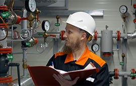 An engineer in a hard hat recording service details