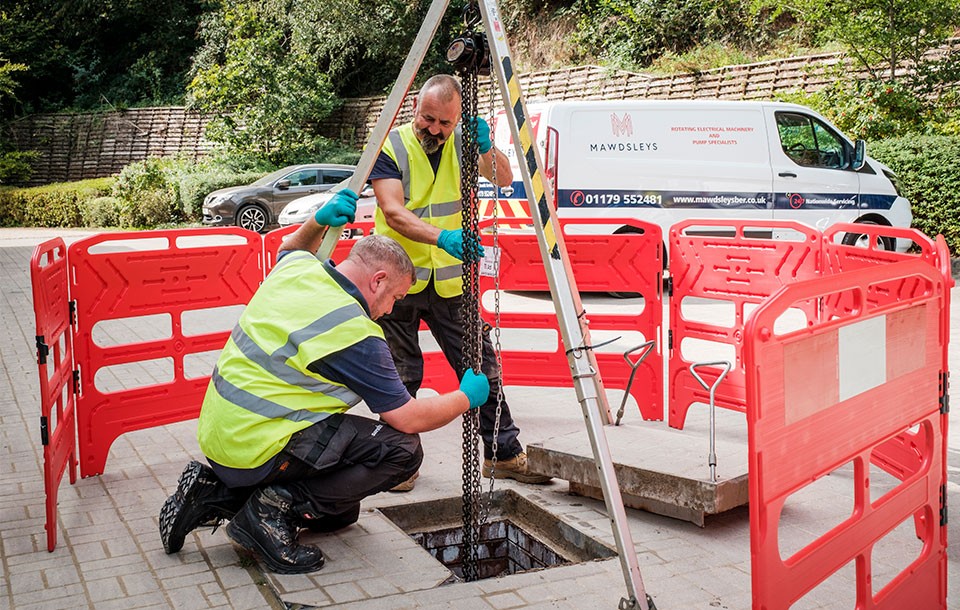 Engineers working on site doing a pump service