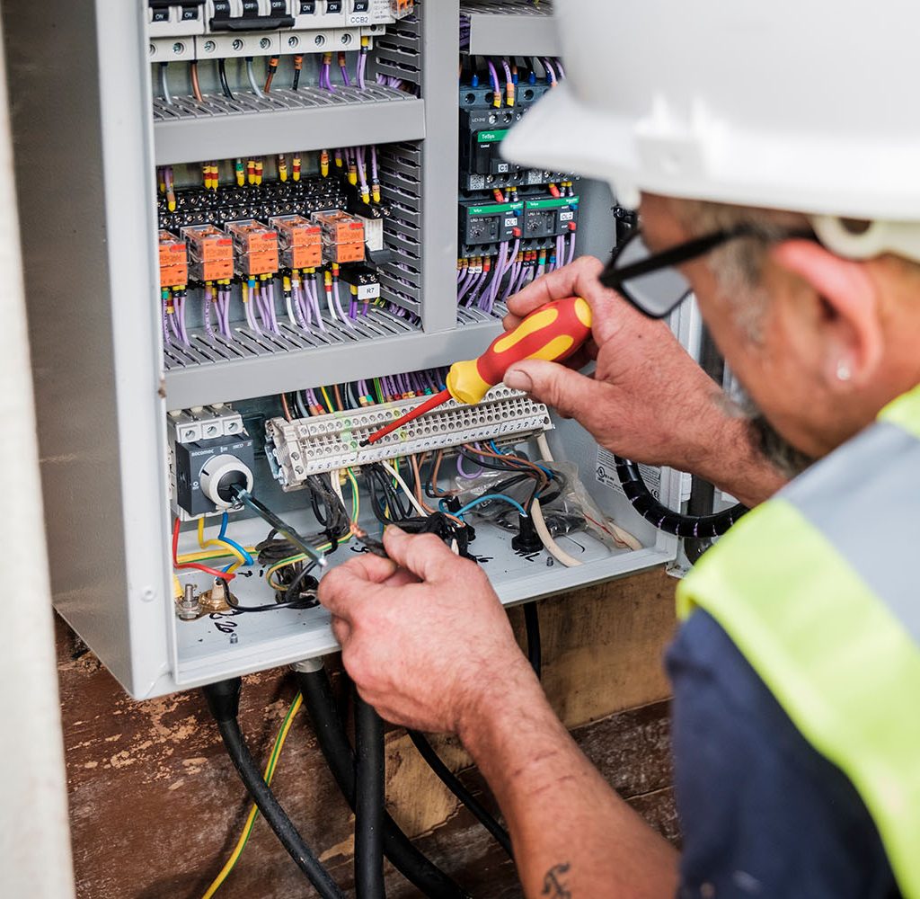 An image of an engineer fixing a control panel
