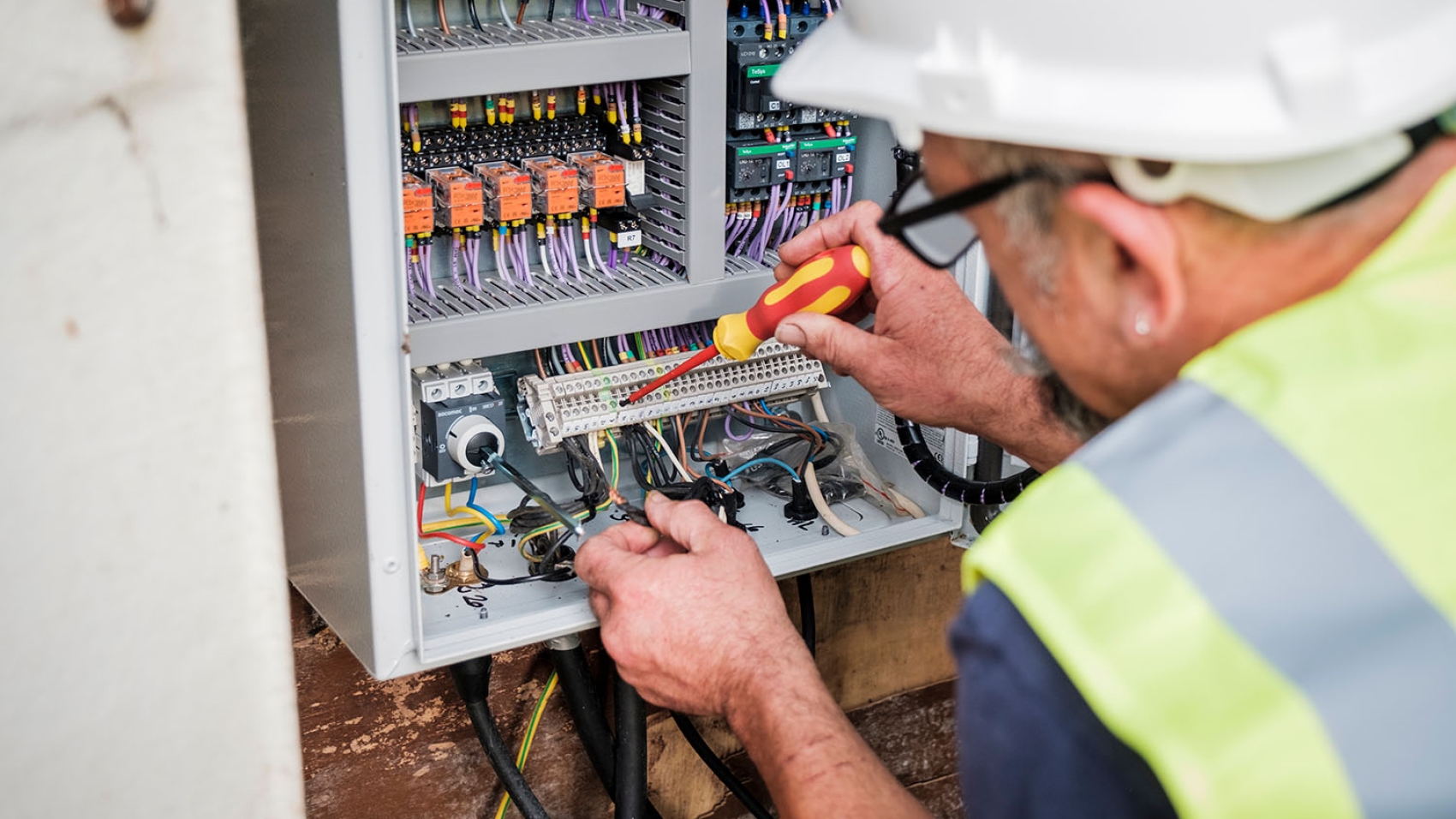 An image of an engineer fixing a control panel