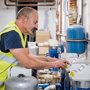 An image of an engineer programming a booster set