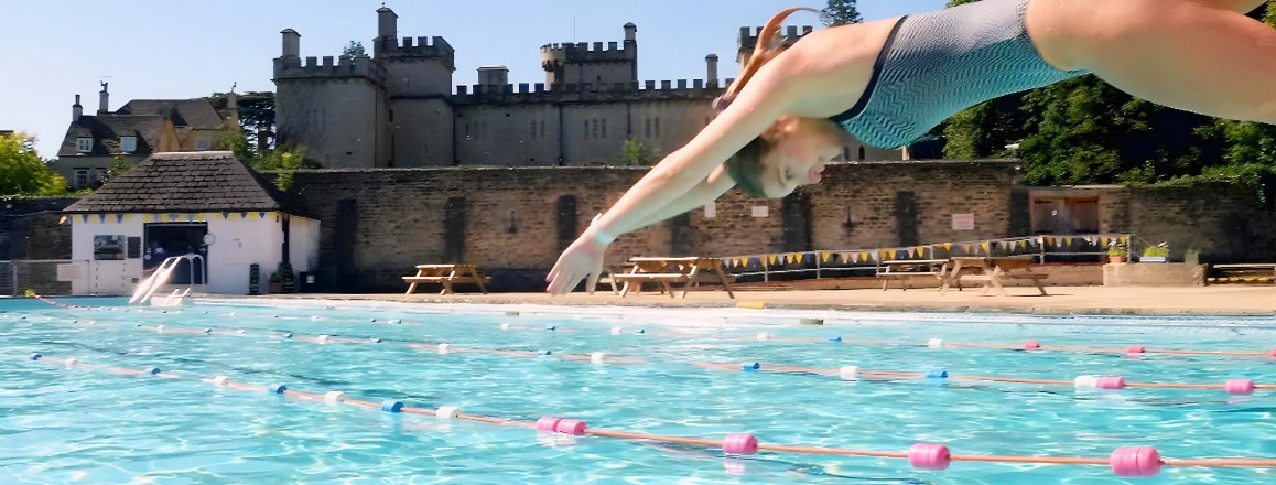 An image of a girl jumping into a pool